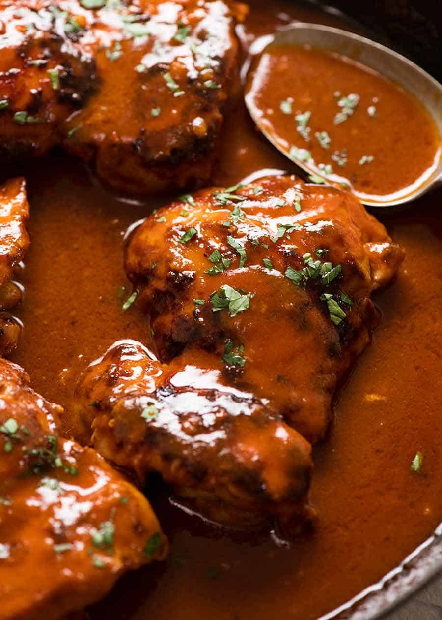 Close up of Sticky Pantry Chicken thighs in skillet, fresh off the stove