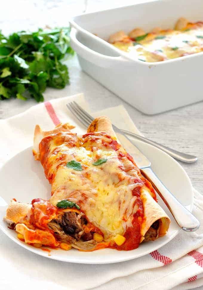 Pulled Pork Enchiladas - Amazing enchiladas stuffed with pork carnitas and topped with a homemade Enchilada Sauce! recipetineats.com