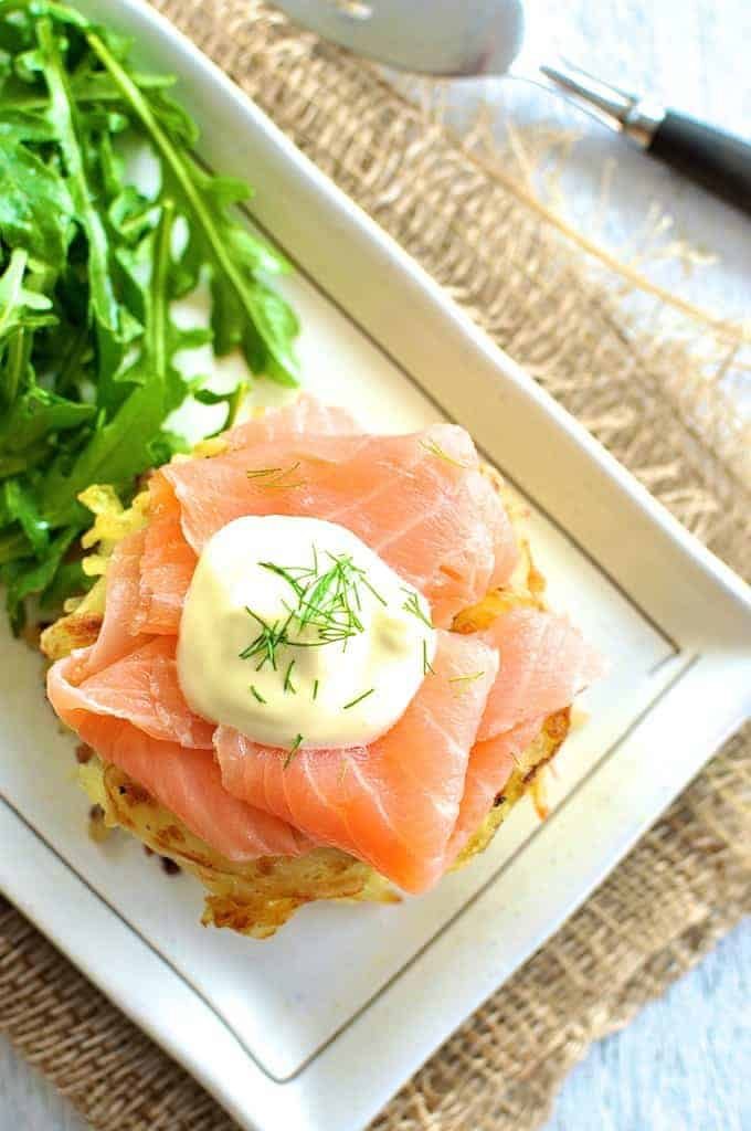 Overhead photo of Smoked Salmon Potato Rosti Stack with a rocket salad on the side.