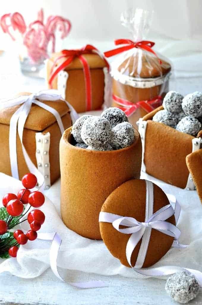 Festive spread of Gingerbread Boxes and Mason Jars tied with ribbons and filled with chocolate truffle balls.