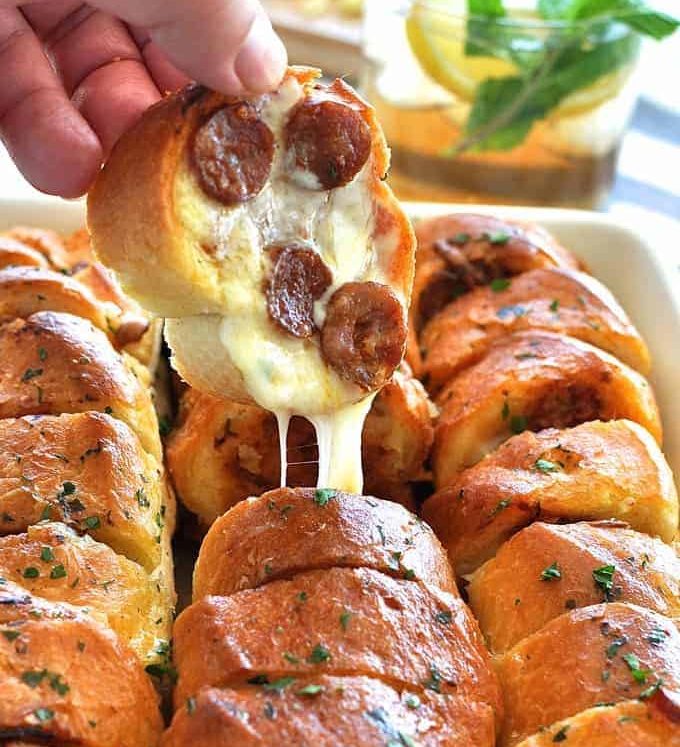 Pulling a piece of Pull Apart Pizza Bread out