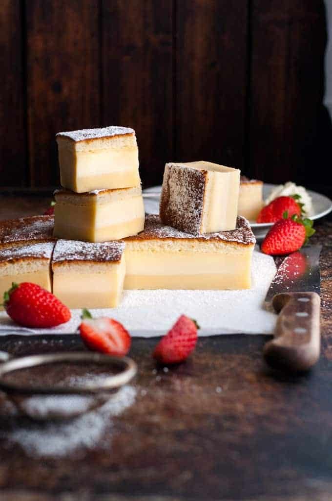 A pile of slices of Magic Three Layer Custard Cake