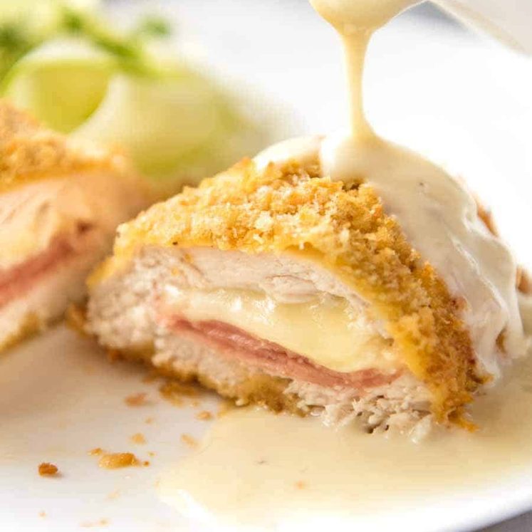 Close up of Dijon Cream Sauce being poured over Easy Chicken Cordon Bleu