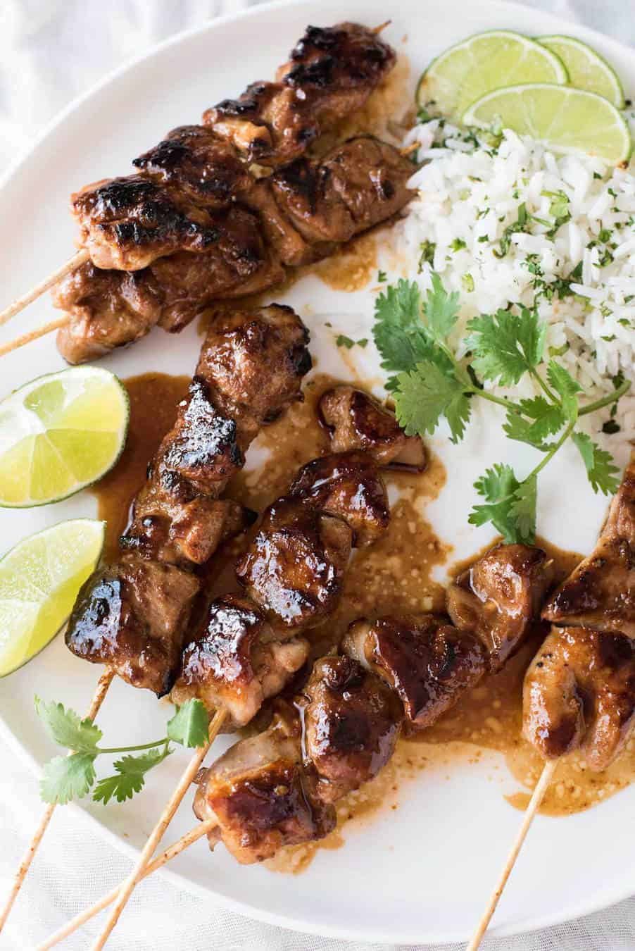 Honey Sriracha Chicken Skewers on a white plate with a side of coconut lime cilantro rice.