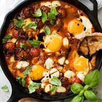 Caprese Baked Eggs drizzled with balsamic vinegar, with toast