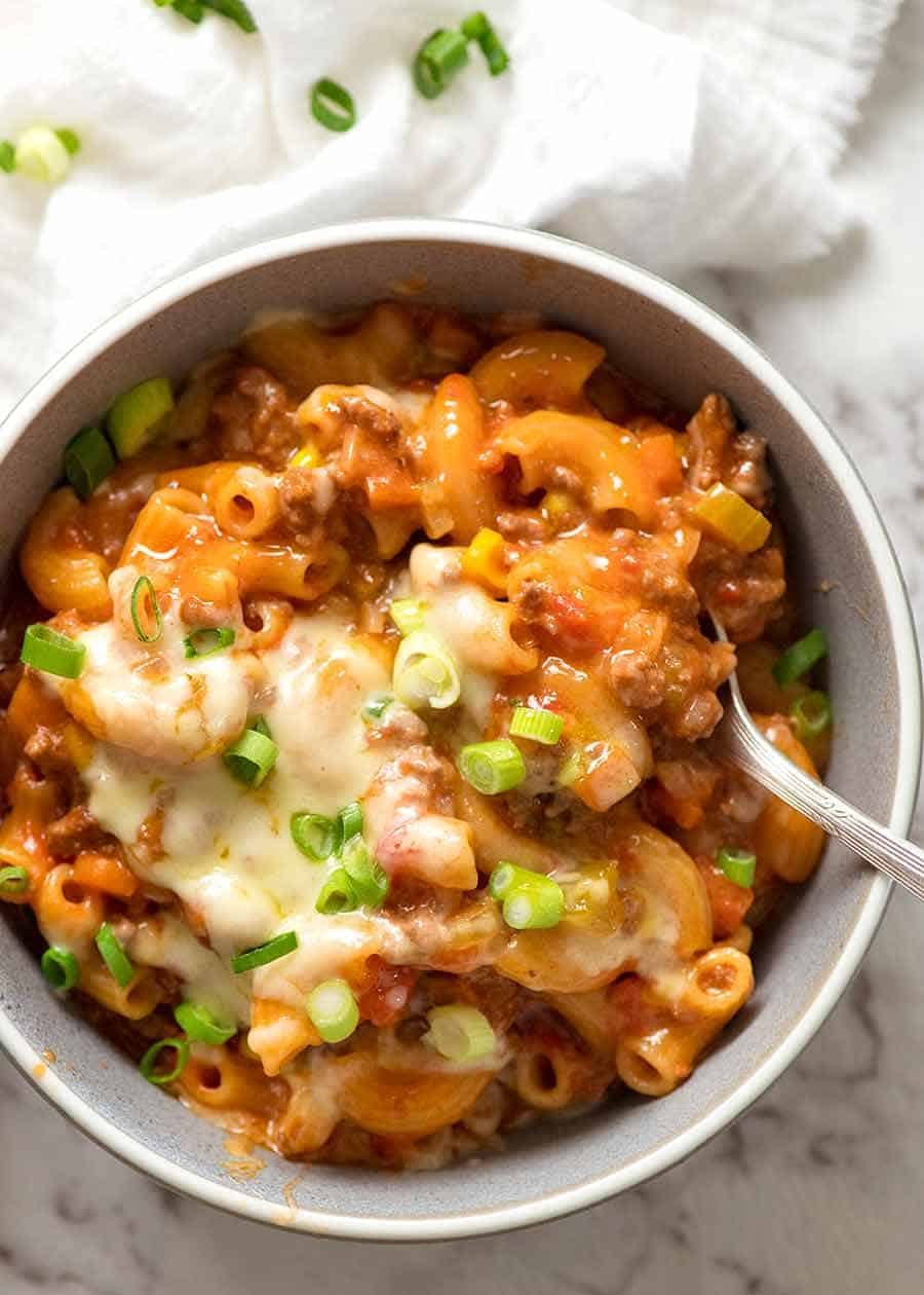 Cheeseburger Casserole in a rustic pale blue bowl, ready to be eaten