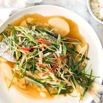 A Chinese Steamed Fish topped with Ginger and Shallots and seasonings, with hot oil poured over it to create a dramatic sizzle and an amazing sauce. So simple, yet so utterly delicious. Steam OR bake the fish! recipetineats.com