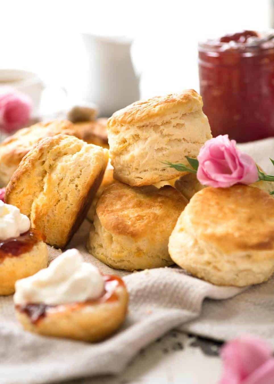 A pile of plain scones on a soft tea towel.