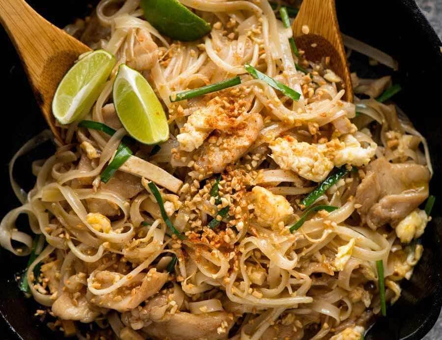 Chicken Pad Thai in a black skillet, fresh off the stove, ready to be served.