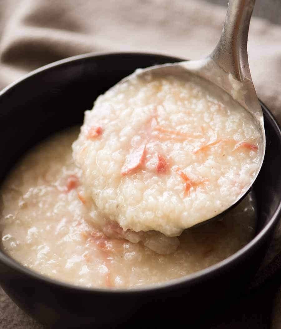 Chinese Ham Bone Rice Soup (Congee) being ladled into a bowl