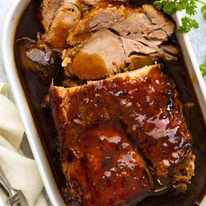 Slow Cooker Pork Loin Roast in a white dish, ready to be served