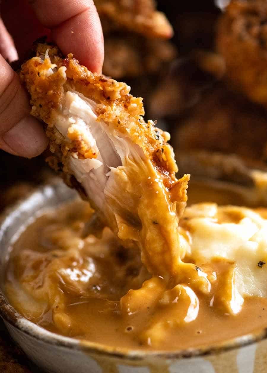 Dunking Fried Chicken into potato and gravy