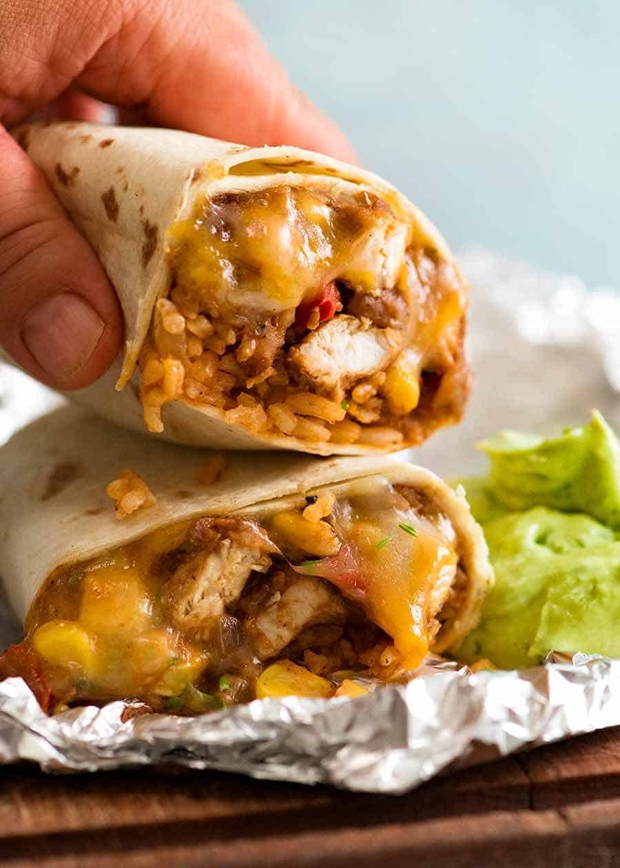 Hand picking up Chicken Burrito