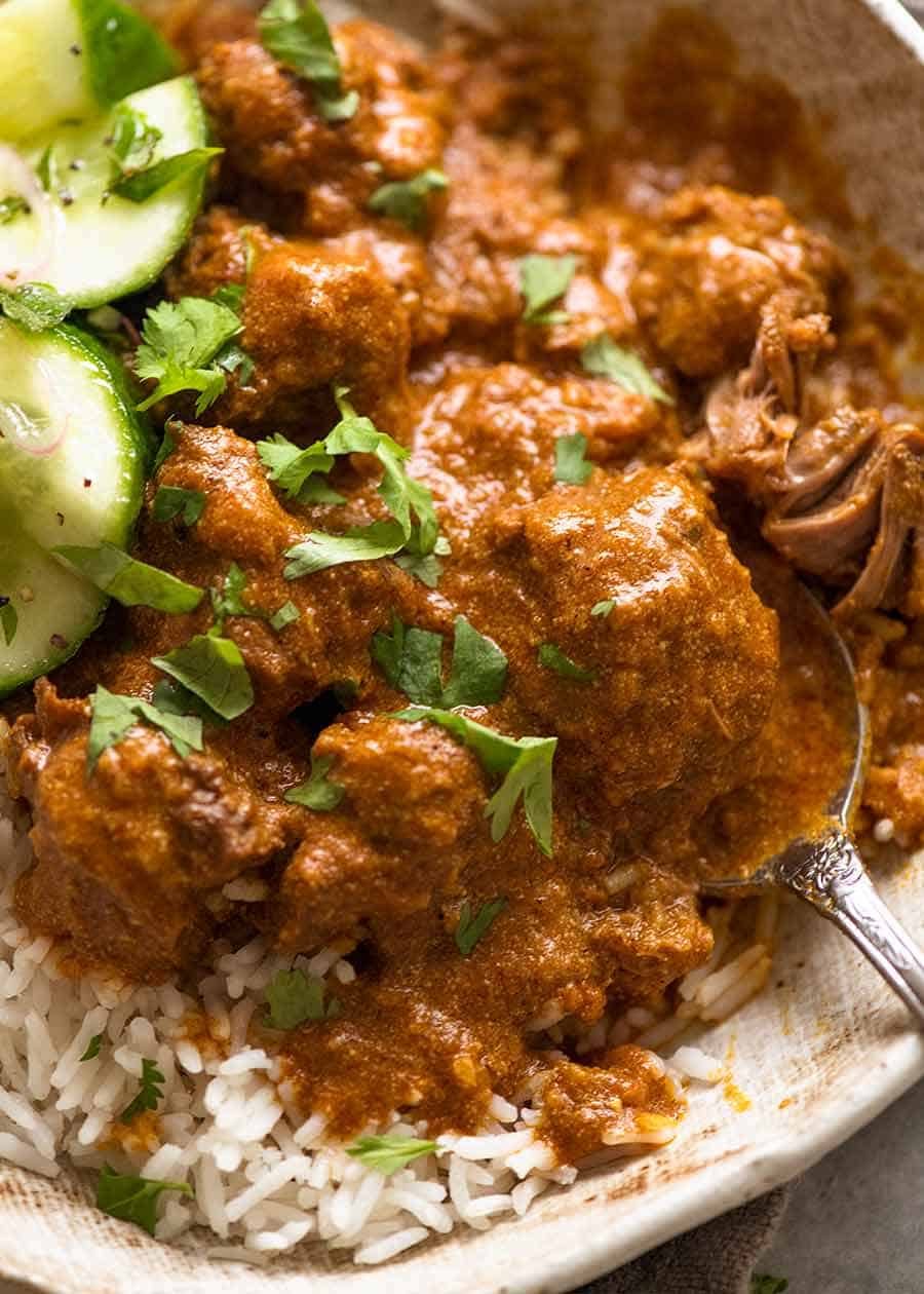 Close up of Rogan Josh in a rustic bowl, served over basmati rice