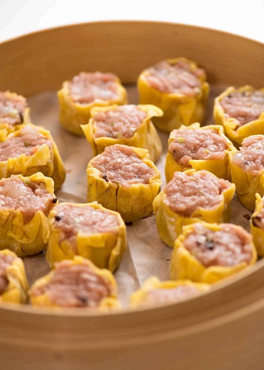 Raw Siu Mai - Chinese Steamed Dumplings in a bamboo steamer, ready to be cooked