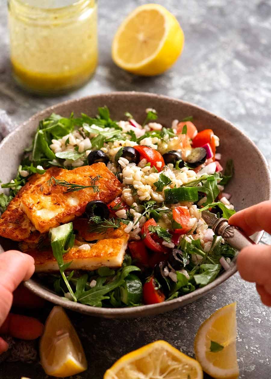Bowl of Brown Rice Salad with halloumi, ready to be eaten