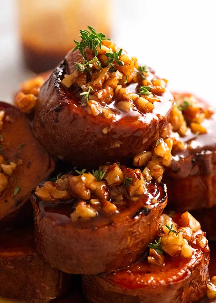 Close up of pile of Slow Roasted Fondant Sweet Potatoes with Maple Butter on a plate, ready to be served