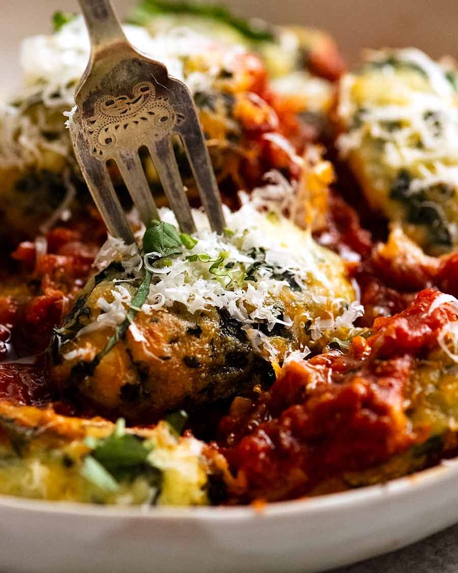 Fork picking up a piece of Malfatti - Italian Spinach Ricotta Dumplings